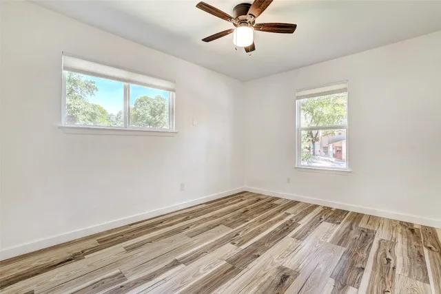 a view of a room with a window and a ceiling fan