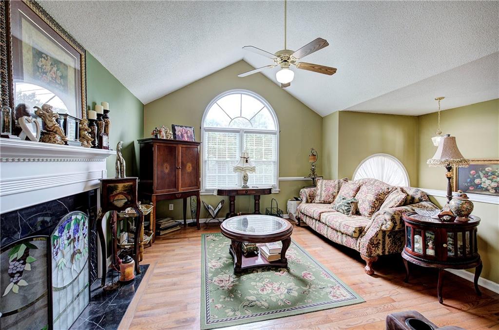 218 Gilreath Road Southeast Cartersville, GA 30121 - Photo 7 of 27 a living room with furniture a fireplace and a large window