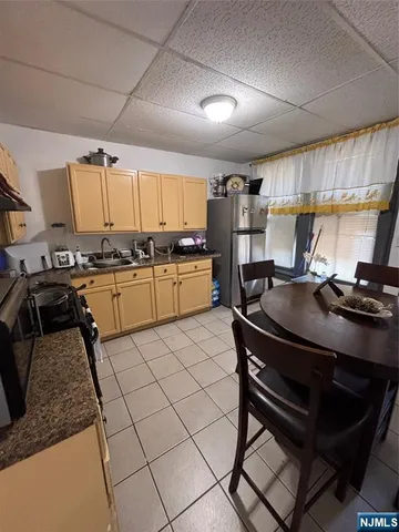 a kitchen with a sink appliances and cabinets