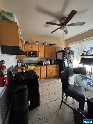 a living room with lots of furniture and kitchen view