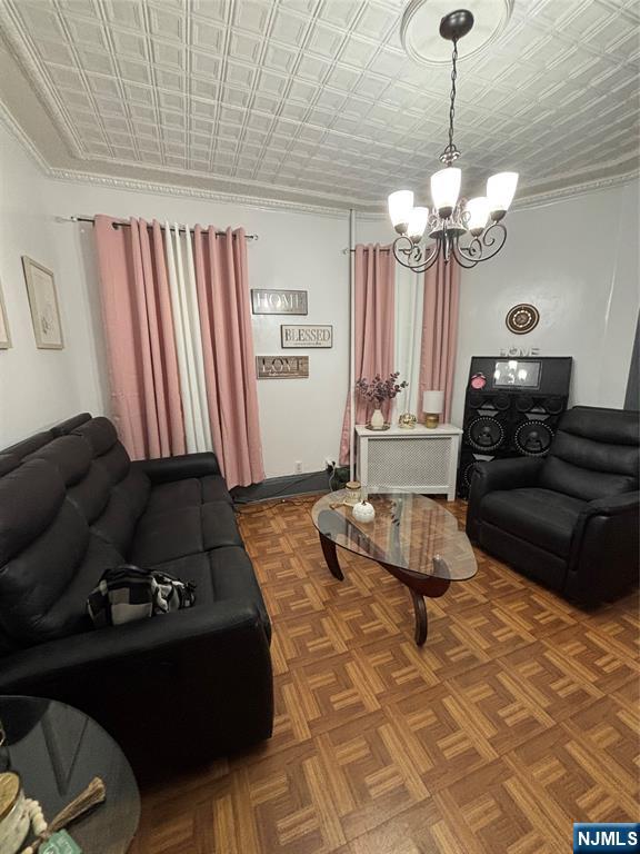 552 River Street Paterson, NJ 07524 - Photo 6 of 21 a living room with furniture and a chandelier