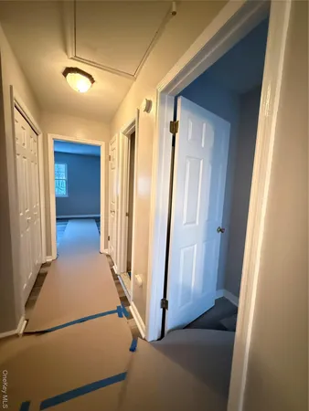 a view of a hallway with hallway with wooden floor