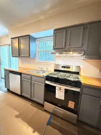 a kitchen with stainless steel appliances granite countertop a stove and a sink