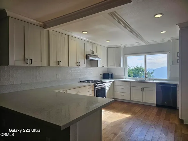 a kitchen with a sink stove and cabinets