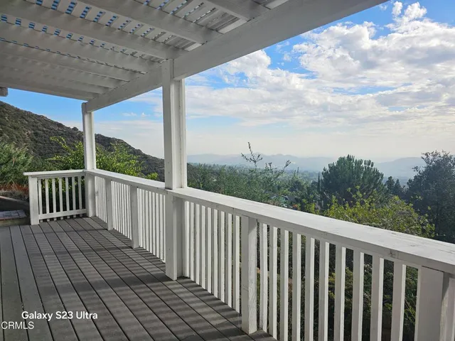a balcony with wooden floor in outdoor space