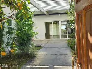 a view of yellow house with a yard