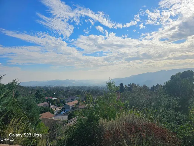 a view of a city with lush green forest