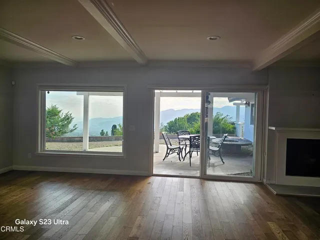 a view of a room with window and wooden floor