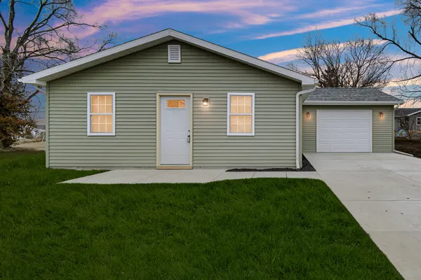 a front view of a house with a garage