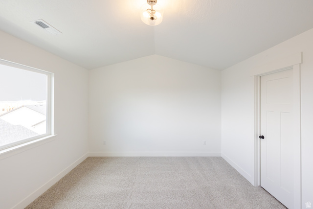4812 Heartwood Road, Unit 424 Mapleton, UT 84664 - Photo 14 of 20 Empty room featuring light carpet and lofted ceiling