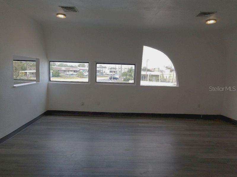 100 East Shell Point Road Ruskin, FL 33570 - Photo 22 of 41 a view of an empty room with wooden floor and windows