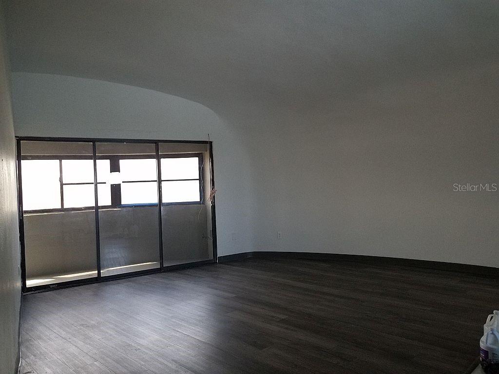 100 East Shell Point Road Ruskin, FL 33570 - Photo 29 of 41 an empty room with wooden floor and windows