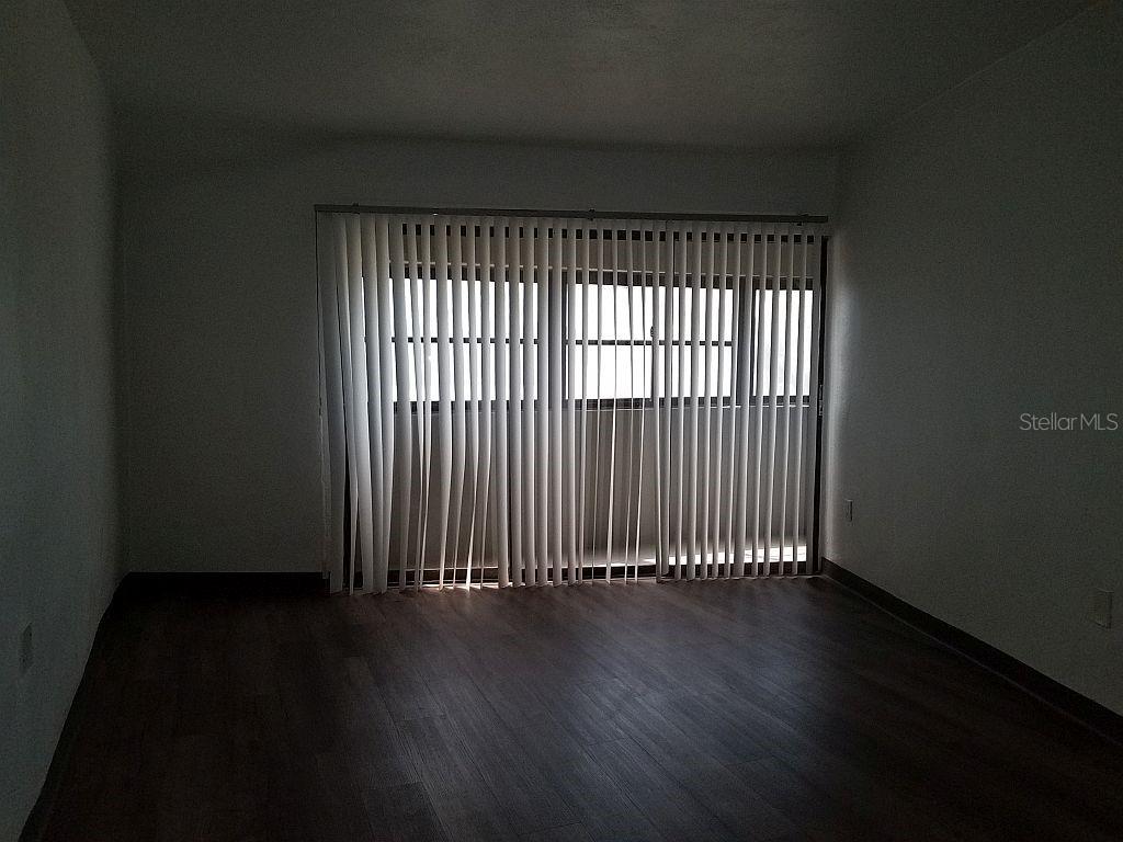 100 East Shell Point Road Ruskin, FL 33570 - Photo 33 of 41 an empty room with wooden floor and windows