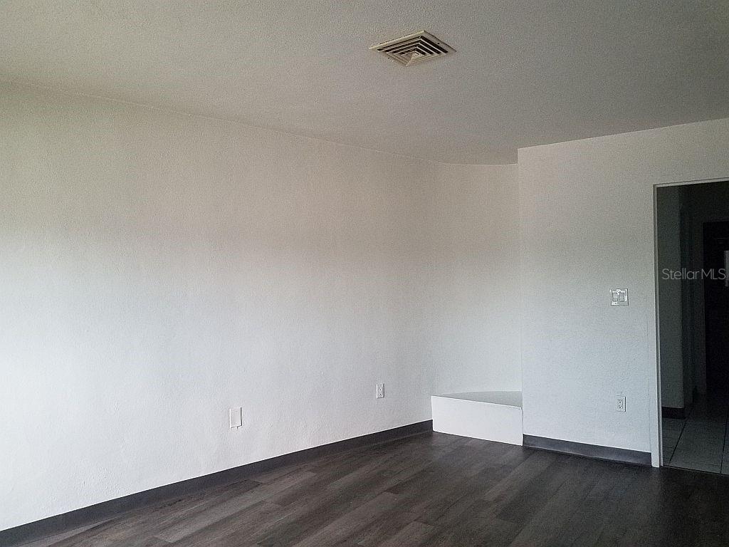 100 East Shell Point Road Ruskin, FL 33570 - Photo 35 of 41 a view of an empty room with wooden floor and a window