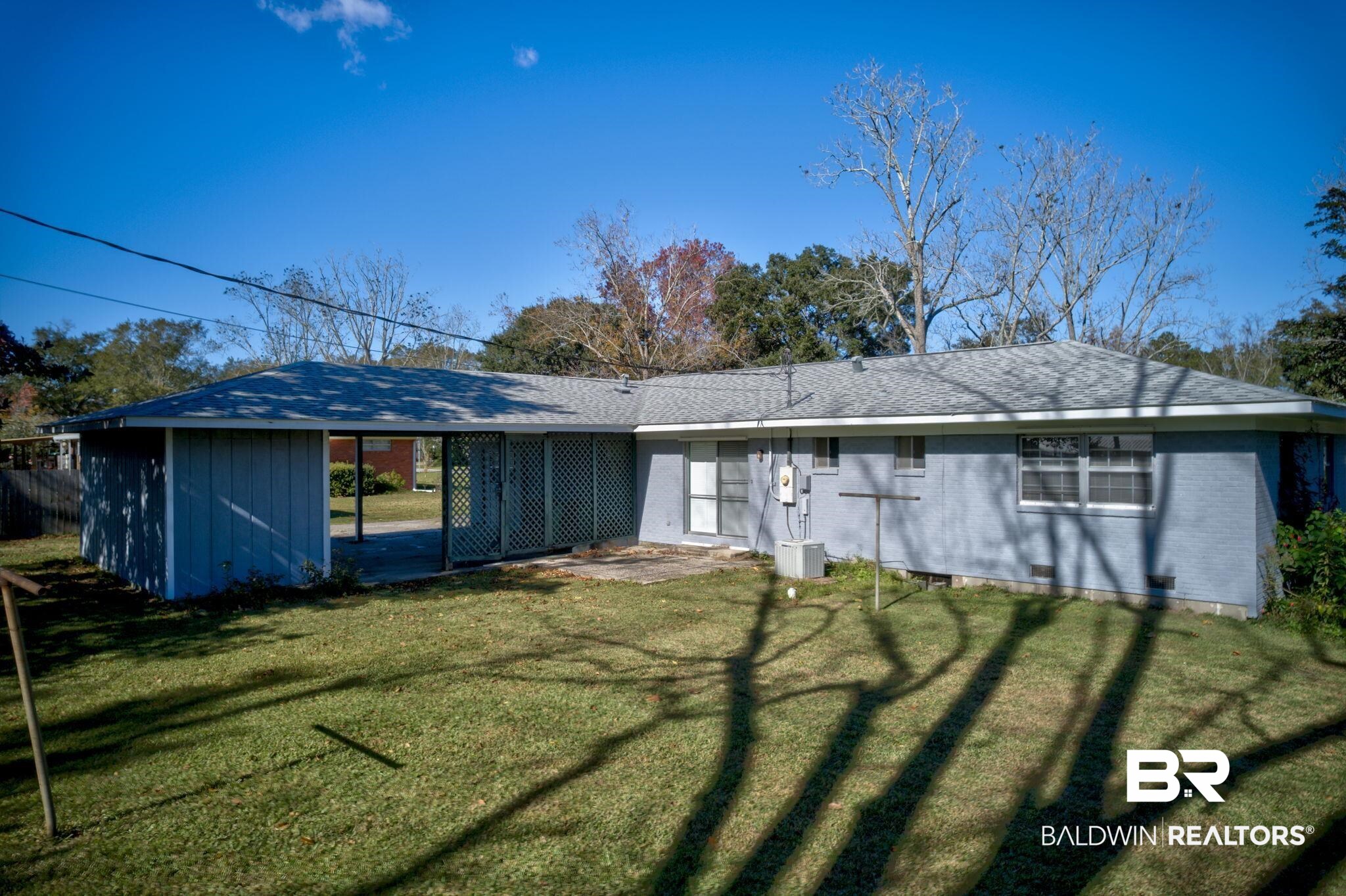 606 East Myrtle Avenue Foley, AL 36535 - Photo 13 of 24 Back of property featuring a lawn
