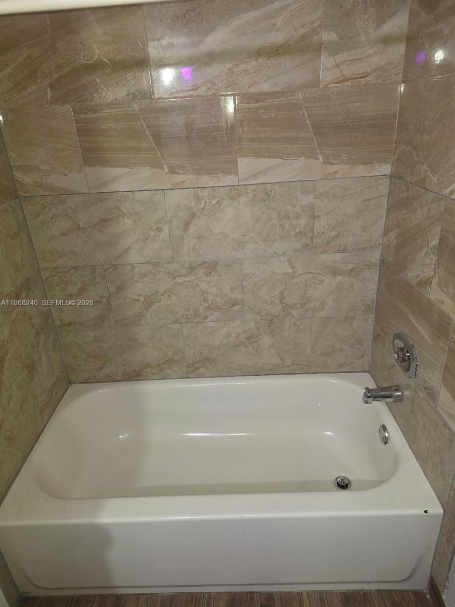 3399 Foxcroft Road, Unit 203 Miramar, FL 33025 - Photo 15 of 15 a bathroom with a bathtub