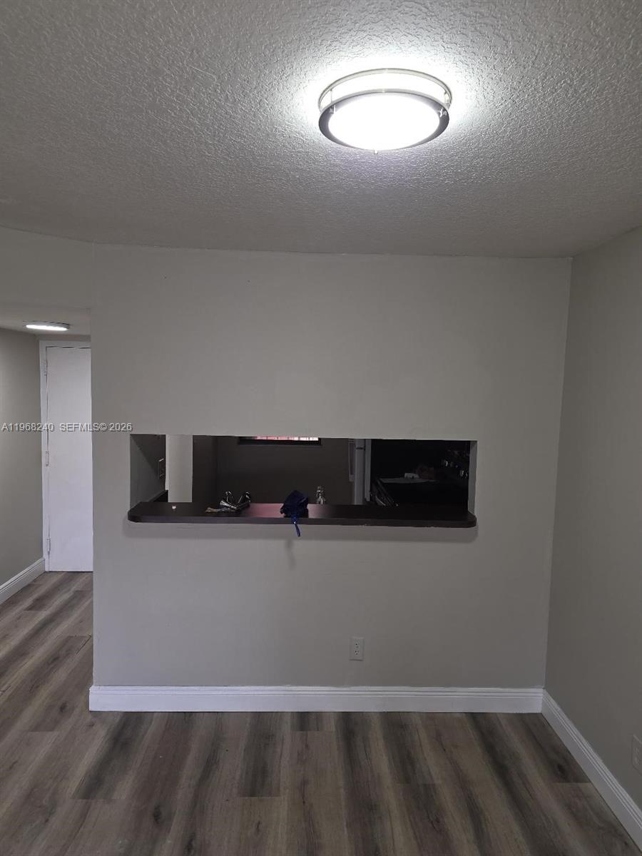 3399 Foxcroft Road, Unit 203 Miramar, FL 33025 - Photo 3 of 15 a view of entryway with wooden floor