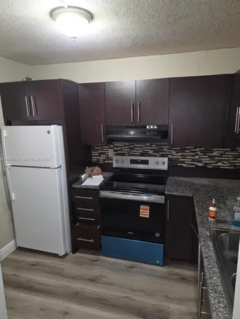 a kitchen with a stove and a refrigerator