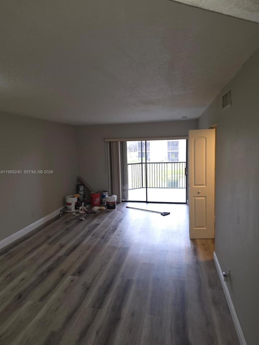 3399 Foxcroft Road, Unit 203 Miramar, FL 33025 - Photo 7 of 15 a view of a room with wooden floor and window