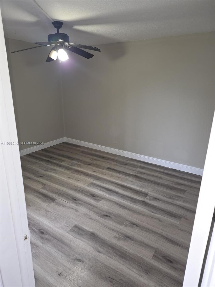 3399 Foxcroft Road, Unit 203 Miramar, FL 33025 - Photo 10 of 15 a view of an empty room with wooden floor