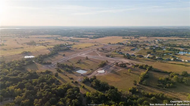 an aerial view of a residential houses with outdoor space