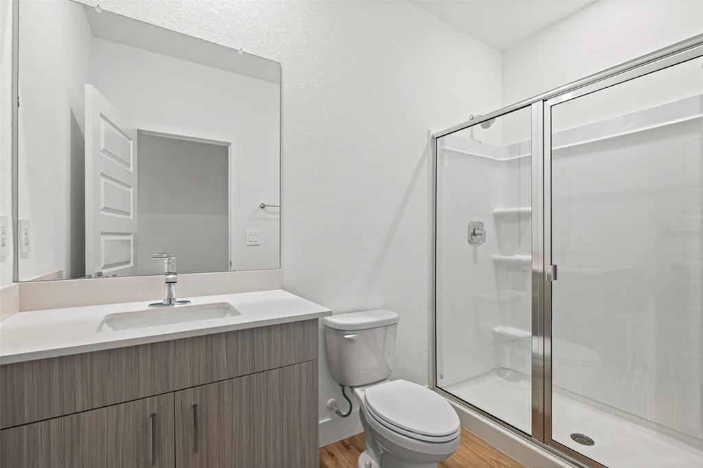 8025 Gulfstream Court Lakewood Ranch, FL 34202 - Photo 18 of 44 a bathroom with a sink toilet and shower