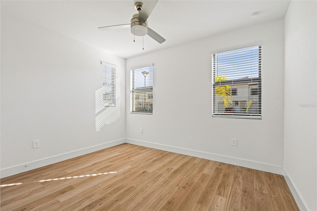 8025 Gulfstream Court Lakewood Ranch, FL 34202 - Photo 20 of 44 a view of empty room with wooden floor and fan