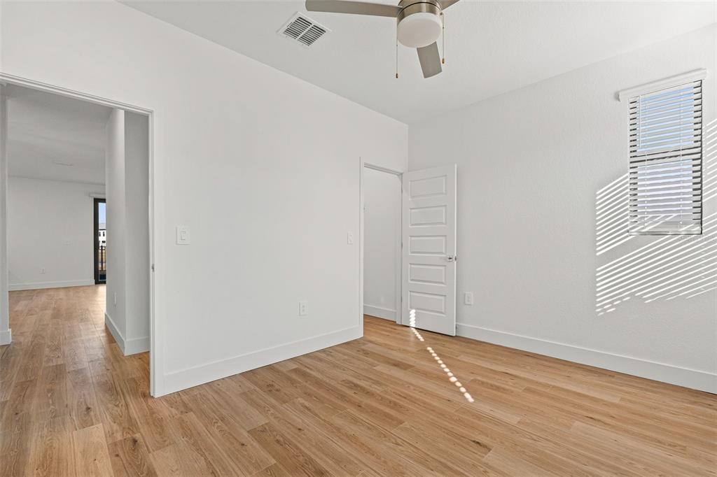 8025 Gulfstream Court Lakewood Ranch, FL 34202 - Photo 21 of 44 wooden floor in an empty room with a window