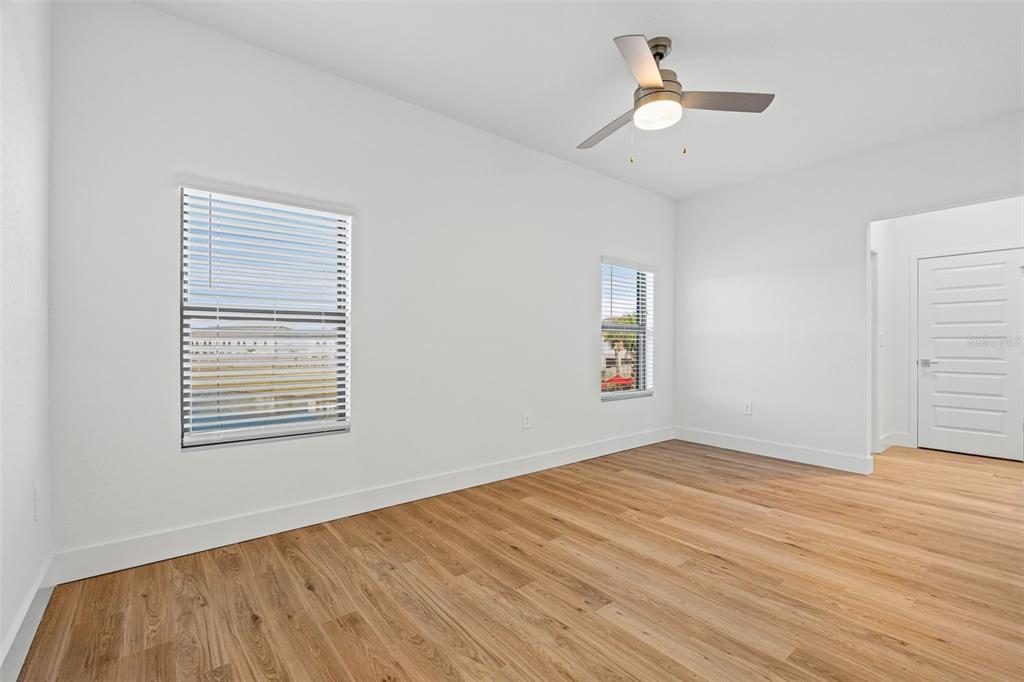 8025 Gulfstream Court Lakewood Ranch, FL 34202 - Photo 23 of 44 a view of an empty room with wooden floor and a window