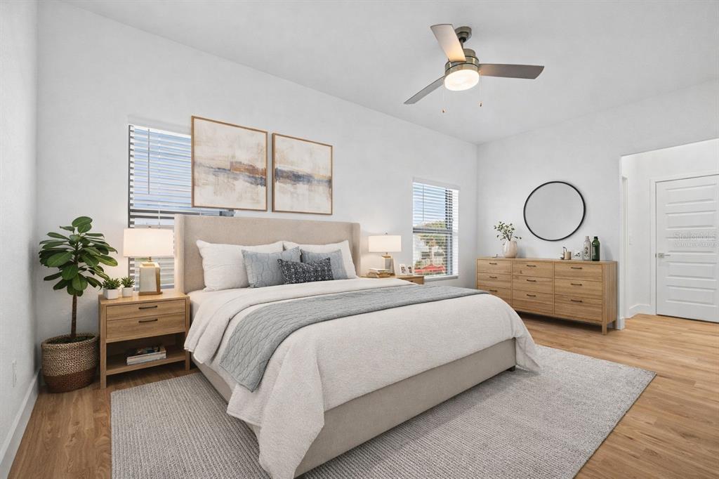 8025 Gulfstream Court Lakewood Ranch, FL 34202 - Photo 24 of 44 a bedroom with bed and a chandelier