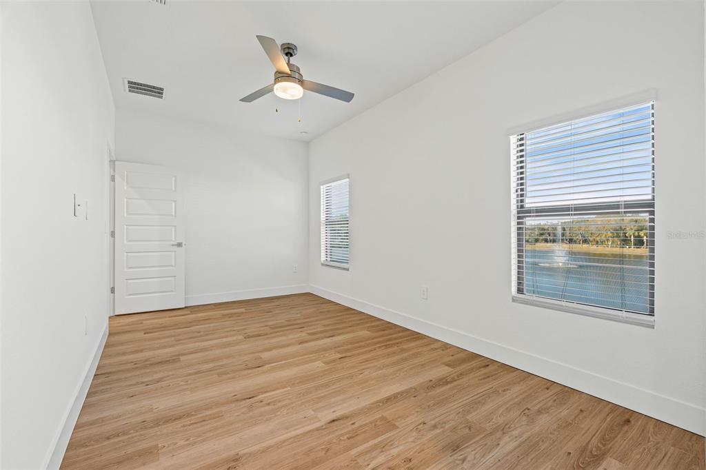 8025 Gulfstream Court Lakewood Ranch, FL 34202 - Photo 25 of 44 a view of an empty room with window and wooden floor