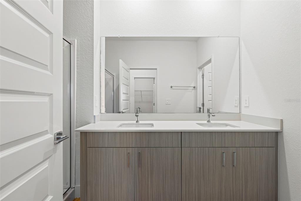 8025 Gulfstream Court Lakewood Ranch, FL 34202 - Photo 27 of 44 a bathroom with a double vanity sink and mirror