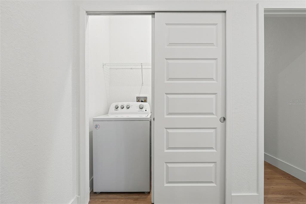 8025 Gulfstream Court Lakewood Ranch, FL 34202 - Photo 30 of 44 a utility room with cabinets washer and dryer