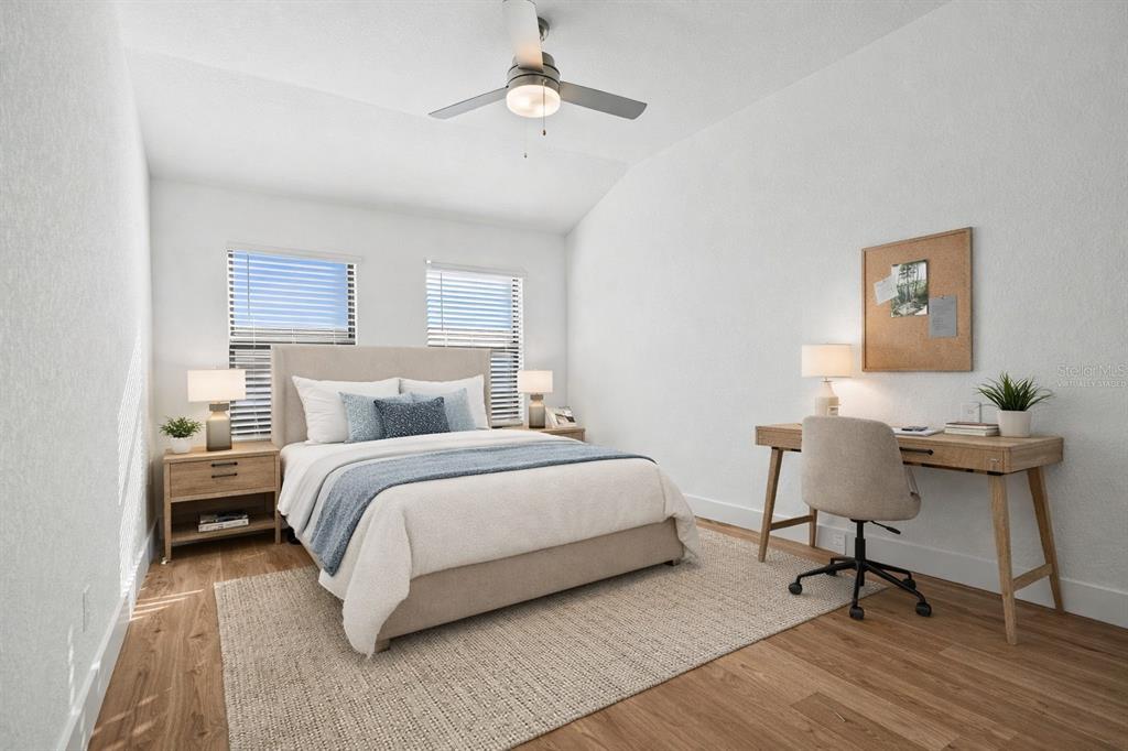 8025 Gulfstream Court Lakewood Ranch, FL 34202 - Photo 31 of 44 a bedroom with a bed and a chair