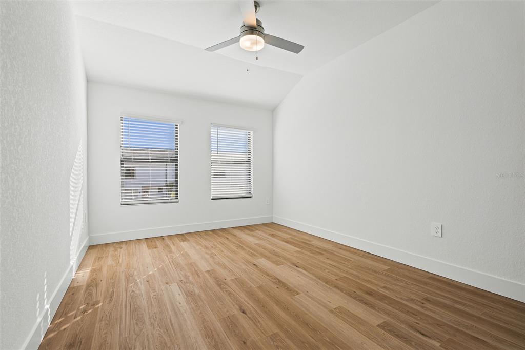 8025 Gulfstream Court Lakewood Ranch, FL 34202 - Photo 32 of 44 wooden floor in an empty room with a window