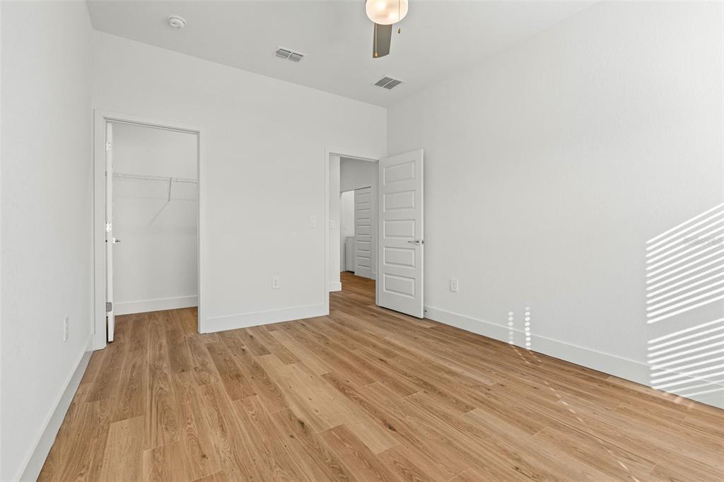 8025 Gulfstream Court Lakewood Ranch, FL 34202 - Photo 33 of 44 wooden floor in an empty room with a window