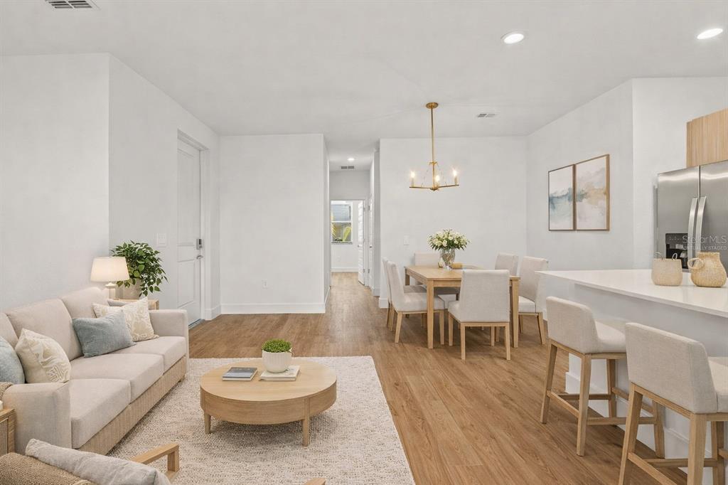 8025 Gulfstream Court Lakewood Ranch, FL 34202 - Photo 10 of 44 a living room with furniture and a wooden floor
