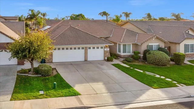 a kitchen with stainless steel appliances a sink a stove a refrigerator cabinets and a counter top space