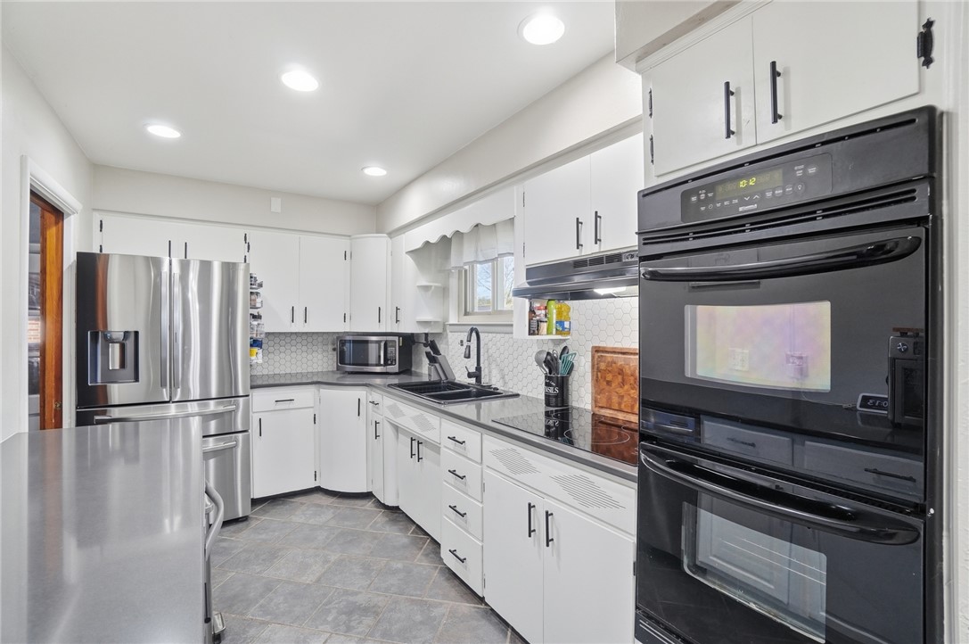 1325 Chelsea Road Troy, OH 45373 - Photo 14 of 42 This modern kitchen features bright cabinetry, sleek appliances, and durable flooring.
