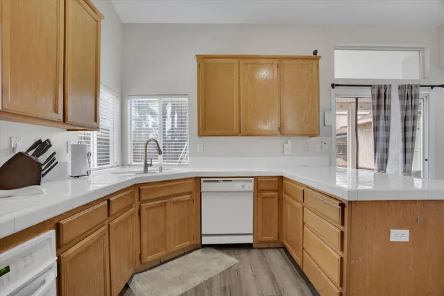 a kitchen with stainless steel appliances granite countertop a sink stove and cabinets