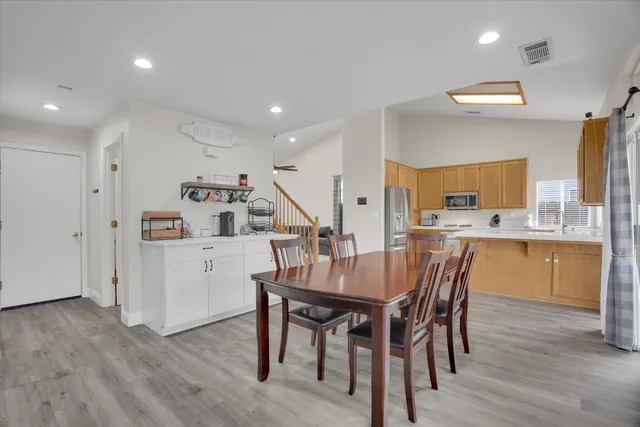 a view of a dining room with furniture and wooden floor
