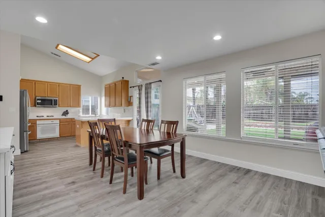 a view of a dining room with furniture window and wooden floor