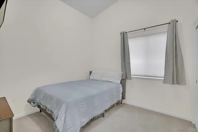 a bedroom with a bed and a mirror