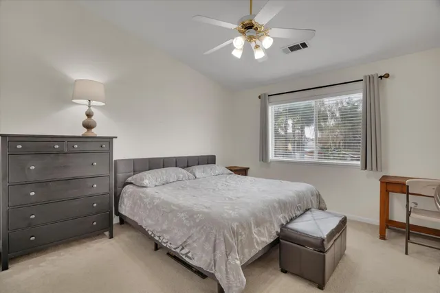 a bedroom with a bed and window