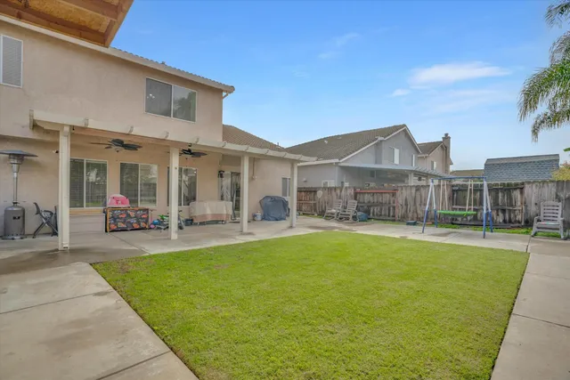 a view of a house with a yard patio and swimming pool