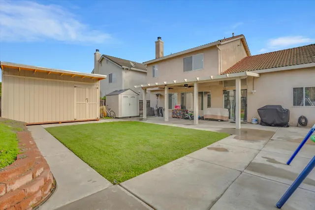 a front view of a house with a garden and plants