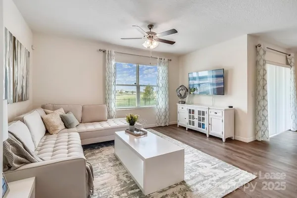 a living room with furniture and a large window