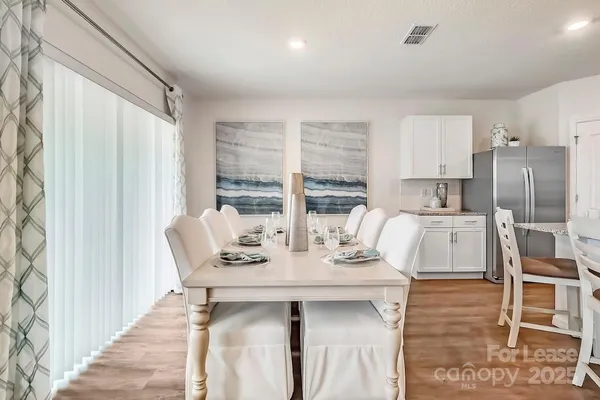 a dining room with furniture and wooden floor