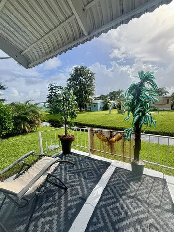 a view of a backyard with sitting area