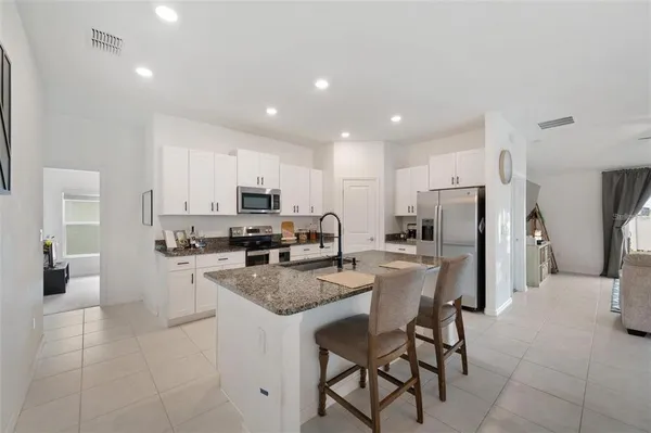 a kitchen with refrigerator and cabinets
